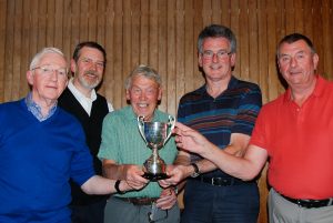 The winning team receive the trophy from organiser John Hayhurst (centre)