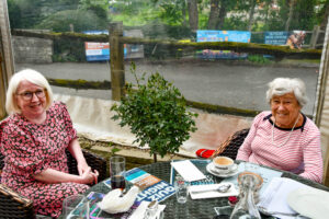 Incoming 'First Lady' presents a rose bush to outgoing 'First Lady' Denise