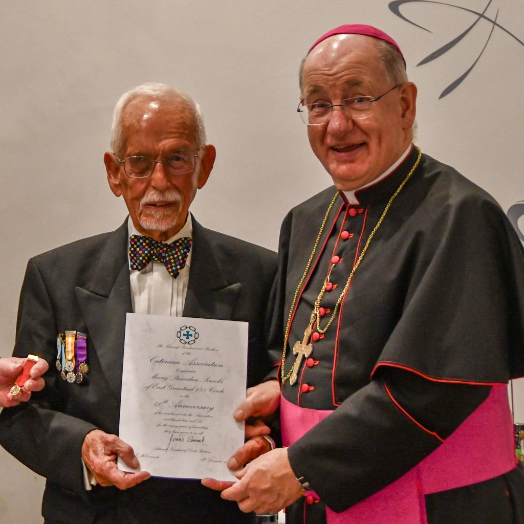 Bishop Richard presents a 40 year scroll to Max Siwicki