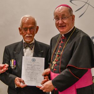 Bishop Richard presents a 40 year scroll to Max Siwicki